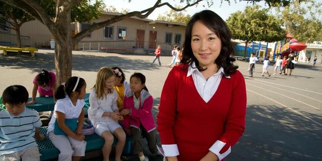 A woman works with young children at an elementary school - Pepperdine University